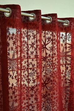 the curtains are red and white with snowflakes on them