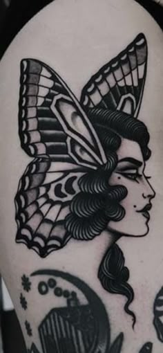 a woman with a butterfly on her head is shown in black and white tattoo art