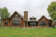 a large house sitting on top of a lush green field