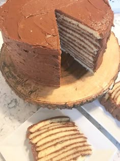 there is a chocolate cake on the table with slices cut out and ready to be eaten