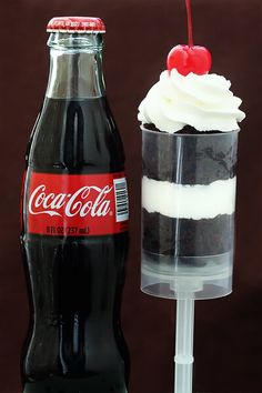 a coca cola bottle next to an ice cream sundae