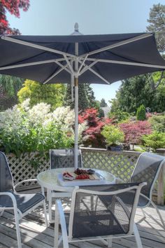 bright outdoor deck with table under umbrella surrounded by colorful trees Private Deck, Hotels Room