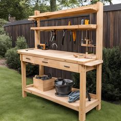 a workbench with tools on it sitting in the middle of some green grass