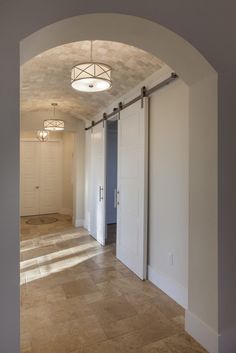 an empty room with white doors and light fixtures