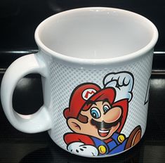 a white coffee cup with an image of mario on it