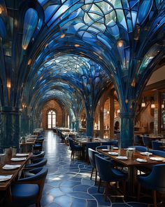 the interior of a restaurant with blue walls and glass ceilinging, along with tables and chairs