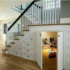 an open closet under the stairs in a house