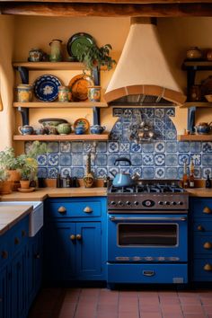 a blue stove top oven sitting inside of a kitchen next to a wall mounted oven