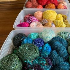 yarns are in plastic containers on a table