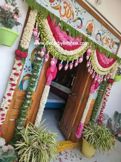 an entrance decorated with flowers and garlands