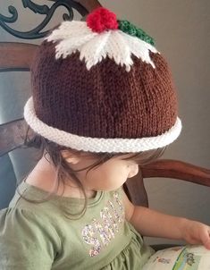 This fun and festive hand- knitted hat is perfect for your little one this holiday season. It's designed to look like a traditional Christmas fig pudding sitting atop a white platter. It's warm, cozy, and would look adorable in a holiday photo shoot. It has a rolled brim so there's room to grow!  Our hat model is 2 years old and wearing the 2-4 year old size. Sizes and Measurements: 0-6 months: Inner circumference 16-20 inches. 7.5 inches from crown to unrolled brim (not including berries). 1 ye Fig Pudding, Holiday Photo Shoot, Figgy Pudding, Hat Model, White Platter, Knitting For Charity, Holiday Photoshoot, Knit Christmas, Knitting Tips