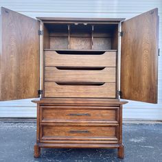 an old wooden dresser with its doors open