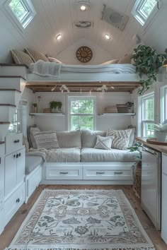 a living room filled with furniture and lots of windows