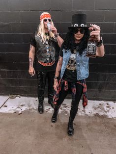 two women dressed up as rockers, one holding a bottle