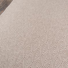 an area rug with a wooden table and chair in the background