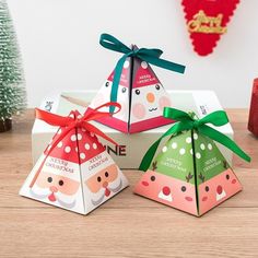 three small boxes with christmas decorations on them