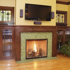 a fireplace with a television above it in a living room