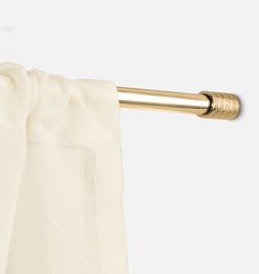 an open curtain with a gold rod on it's end and white drapes