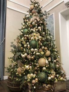 a decorated christmas tree with gold and green ornaments