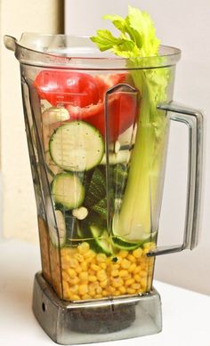 a blender filled with lots of different types of vegetables in it's container