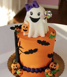 a halloween cake with a ghost on top