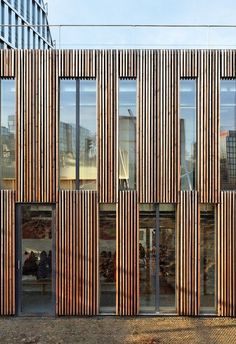 a building with many windows and wooden slats