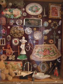 a display case filled with lots of different types of jewelry and knick knacks