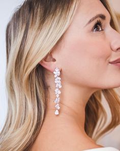 a woman with blonde hair wearing large earrings