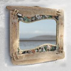 a mirror made out of wood with shells on it