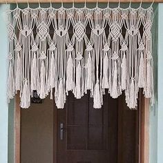 the door is decorated with white macrame tassels