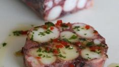 a piece of meat sitting on top of a white plate