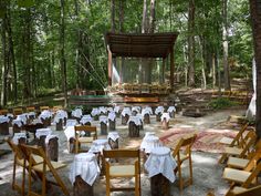 tables and chairs are set up in the woods