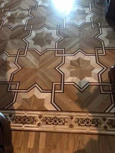 a wooden floor with an intricate design on it