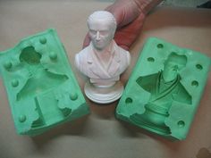 two plastic molds are shown with a man's head in the middle