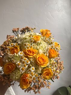 a vase filled with yellow and white flowers