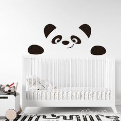 a panda bear wall sticker in a baby's room with a crib