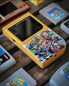 an old nintendo game console sitting on top of a wooden table next to other games