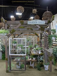 a garden shed with lots of potted plants