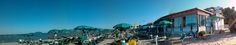 the beach is lined with umbrellas and chairs for people to sit down on it