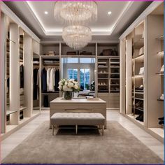 a walk - in closet with chandelier and bench