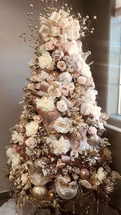 a christmas tree decorated with flowers and ornaments