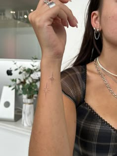 a woman with a small star tattoo on her arm