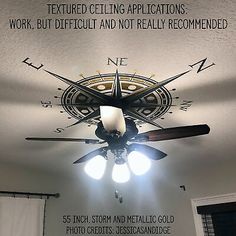 a ceiling fan with three light bulbs on top of it in a room that has white walls and curtains