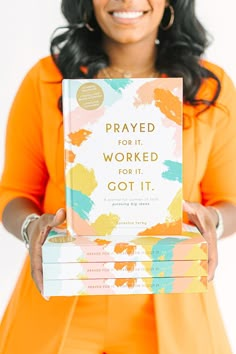 a woman holding up a book that says, pray for it worked for it got it