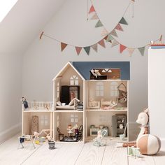 a doll house with lots of furniture and accessories on the floor in front of it