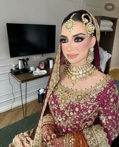 a woman wearing a bridal outfit and jewelry