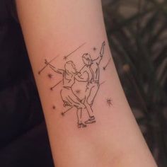 a tattoo on the arm of a woman with a dancing couple holding each other's hands