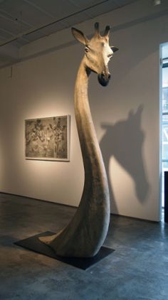 a giraffe statue in an art gallery