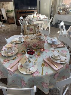 a table set with plates, cups and saucers