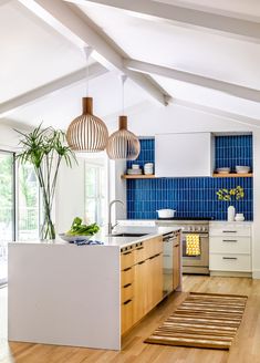 a kitchen with blue tiles and wooden floors